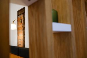 a room with a mirror and a lamp on a shelf at The Chic One, Unirii Square View in Timişoara