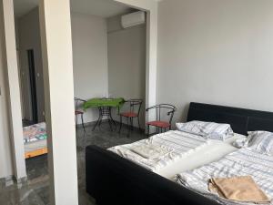 a bedroom with two beds and a table with chairs at Lilla motel in Hegyeshalom
