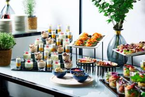 un buffet avec de nombreux types de nourriture sur une table dans l'établissement Hilton Gdansk, à Gdańsk