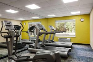 a gym with several tread machines in a room at Baymont by Wyndham Lithia Springs Atlanta in Lithia Springs