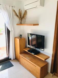 a television sitting on a wooden stand in a room at Marina Dor III -Villa #10 Studio in Santanyi