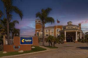 a rendering of a building with a sign in front of it at Comfort Suites Oceanside Camp Pendleton Area in Oceanside
