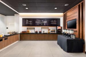 a restaurant with a bar with a tv on the wall at Hampton Inn San Jose Cherry Ave, CA in San Jose