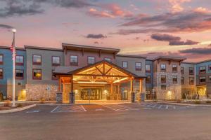 a rendering of the front of a hotel with a parking lot at Cambria Hotel Lake Placid - Lakeside Resort in Lake Placid
