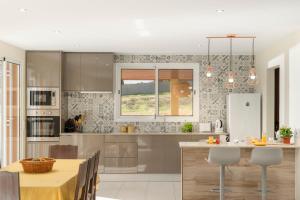 a kitchen with a table and a dining room at Family vacation on Golden Island La Maison Dorée in Porto Santo