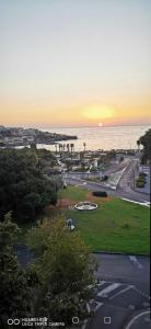 カターニアにあるLuxurious Street Apartmentsの海と夕日を望む公園