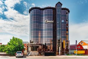 a car parked in front of a building at Amici Grand Hotel in Krasnodar