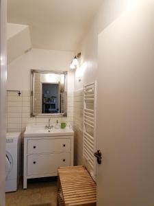 a bathroom with a sink and a mirror at Erdőszéli Házikó Vendégház in Bükkszék