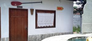 a house with a wooden door and a window at Casamatta Hostel in Pirenópolis