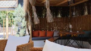 a patio with a table and a couch and chairs at Dİamond Elit Otel&Spa Center in Izmir