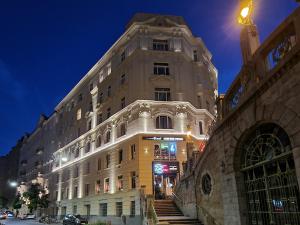a large building with stairs in front of it at night at Pension Mozart - Newly Renovated in Vienna
