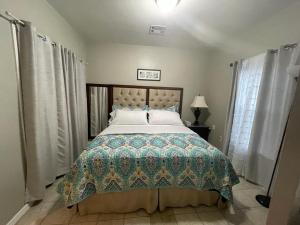 a bedroom with a bed with a quilt on it at Cozy 3Bdr 2Bth 1st floor Unit in New Orleans