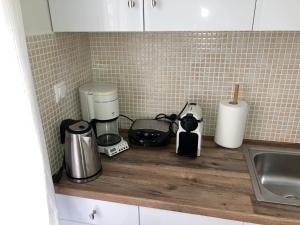 a kitchen counter with various appliances on a counter top at Lamia central luxury apartment in Lamía