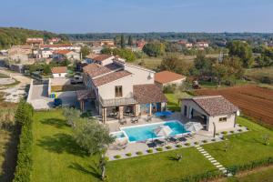 an aerial view of a house with a swimming pool at Villa Mattuzzi in Central Istria with large garden, kids playground and whirlpool in Loborika