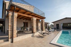a house with a deck and a swimming pool at Villa Mattuzzi in Central Istria with large garden, kids playground and whirlpool in Loborika +36 photos