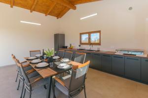 a kitchen and dining room with a table and chairs at Villa Mattuzzi in Central Istria with large garden, kids playground and whirlpool in Loborika