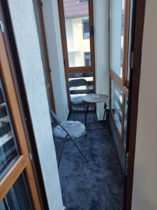 a hallway with a table and a chair in a room at Elizi winter apartments Pamporovo in Pamporovo