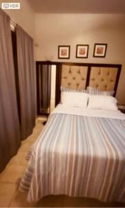 a bedroom with a large bed with white sheets at Cozy 3Bdr 2Bth 1st floor Unit in New Orleans