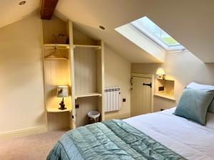 a bedroom with a bed and a skylight at Helm Mount Lodge & Cottages in Kendal
