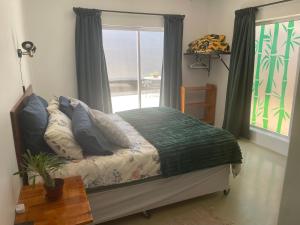 a bedroom with a bed with a view of the ocean at Tortoise Retreat in Langebaan