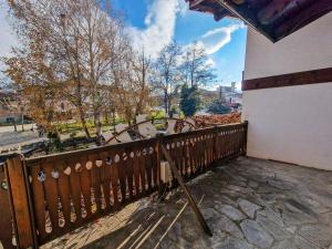 a wooden fence in a park with trees in the background at 8BD Retreat in Bansko Comfort & Mountain Charm by Flat Mаnager in Bansko
