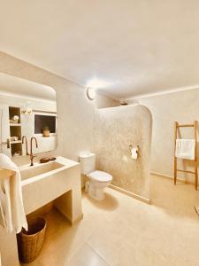 a white bathroom with a sink and a toilet at Amazigh Home in Mirleft