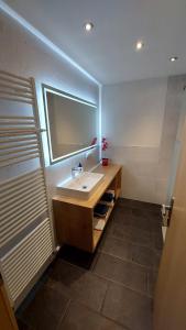 a bathroom with a sink and a mirror at Ferienwohnung Plattner in Schmirn