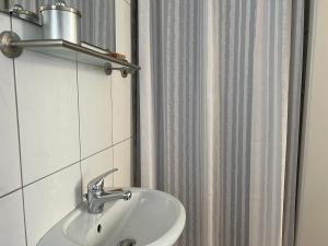a bathroom with a sink and a shower curtain at Schlafmütze in Plauen