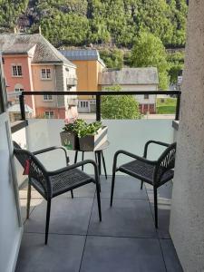 a balcony with two chairs and a table with a plant at Apartment in Rjukan in Rjukan