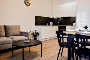 a living room with a couch and a table at VacationClub - Old Town Apartament 9 in Kłodzko
