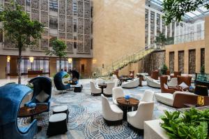 a hotel lobby with a slide and chairs and tables at Intercontinental Jinan City Center, an IHG Hotel in Jinan