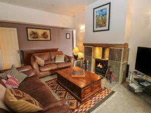 a living room with a couch and a fireplace at Lee House Farm in Halifax