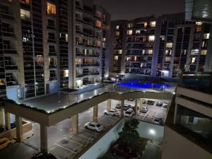 a view of a parking lot in a city at night at Wonderful 1bhk at silicon oasis in Dubai