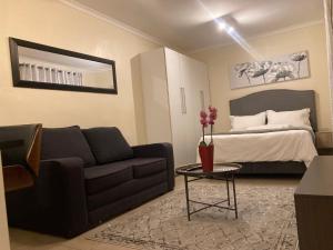 a living room with a couch and a bed at Edenvale corner in Edenvale