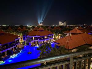 a view of a house with a pool at night at Fabulous 2BR Apartment at 5 Star Resort in Dubai