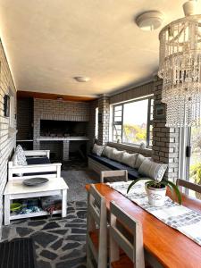 a living room with a table and a fireplace at Huisie by die See in Gansbaai