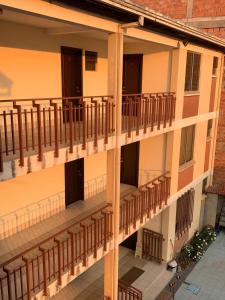 an external view of a building with wooden balconies at Hotel Moderno Coroico in Coroico
