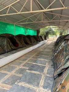 a row of tents sitting inside of a building at Riverfront Resort Dandeli in Dandeli