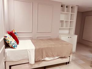 a bedroom with a bed and a book shelf at Flat Beira Mar de Tambaú apto 206 in João Pessoa