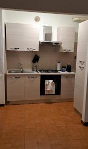 a kitchen with a sink and a stove top oven at APPARTAMENTO SERENA in Bagnolo Mella