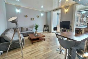 a living room with a couch and a table at Danton | Spacieux | WiFi | Parking | Proche Centre in Troyes