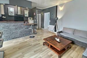 a living room with a couch and a coffee table at Danton | Spacieux | WiFi | Parking | Proche Centre in Troyes