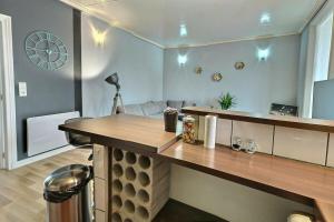 a room with a table and a clock on the wall at Danton | Spacieux | WiFi | Parking | Proche Centre in Troyes