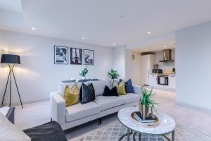 a living room with a white couch and a table at Designer Central Leeds Home by PureStay sleeps 5 in Leeds
