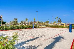 a volleyball court in the sand at a resort at Serenity Haven - Storey Lake #701 by Shine Villas in Kissimmee