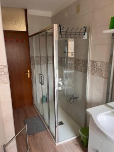 a shower with a glass door in a bathroom at Casa Udine Charme 5 posti letto 