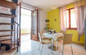 a dining room with a table and chairs at 3 Bedroom Amazing Apartment In Castel Di Tusa in Castel di Tusa