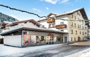 a building with a store on a snowy street at Nice Apartment In Rauris With 1 Bedrooms And Wifi in Rauris