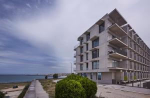 a building next to a body of water at Porto Sunset suite in Vila Nova de Gaia