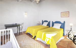 a bedroom with two beds and a desk and a table at Beautiful Home In Pech-Luna With Wi-Fi in Pech-Luna